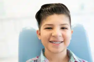 Child wearing traditional braces