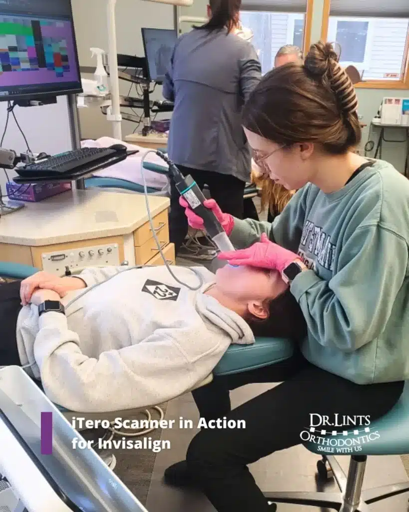 Staff member using an iTero digital scanner on a patient for Invisalign