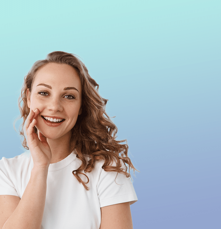 A teenage girl in a white tee-shirt smiling with a perfectly straight smile thanks to her orthodontist in traverse city, suttons bay and elk rapids, michigan